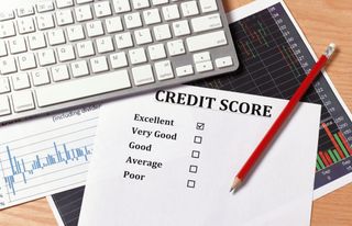 A credit score sheet in front of a keyboard