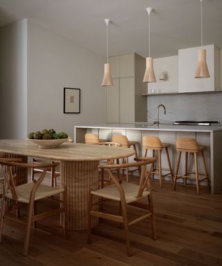 curved dining table in a neutral organic kitchen