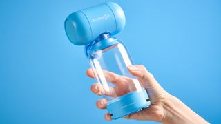 A blue Sodapop Bluetooth speaker that screws onto any regular-sized bottle