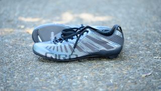 lace up cycling shoes on a shaded cement background
