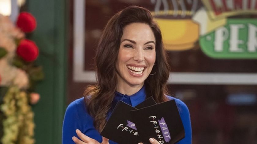 Host Whitney Cummings smiling as she stands in a replica set of Central Perk cafe from nineties sitcom Friends for new game show Fast Friends.