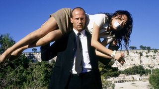 Jason Statham carries Shu Qi on his shoulders in The Transporter (2002)