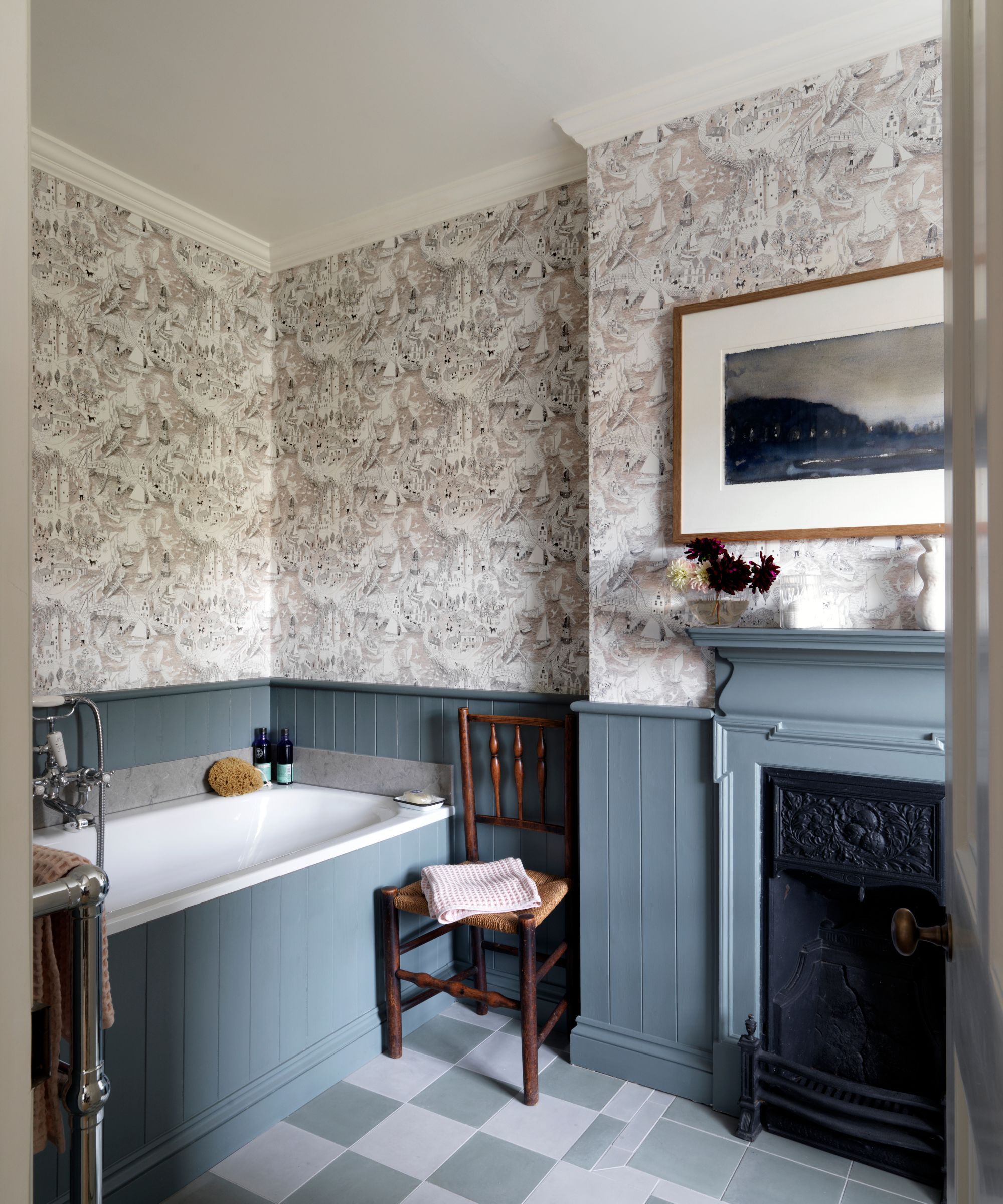 Bathroom with tiled floor, blue painted panelling, fireplace and wallpaper