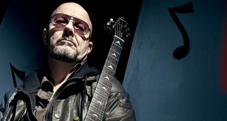 Andy Powell of Wishbone Ash photographed with a V.
