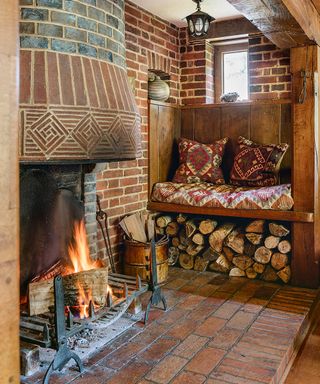 A rustic indoor chiminea fireplace with built in wood seating and under seat log storage