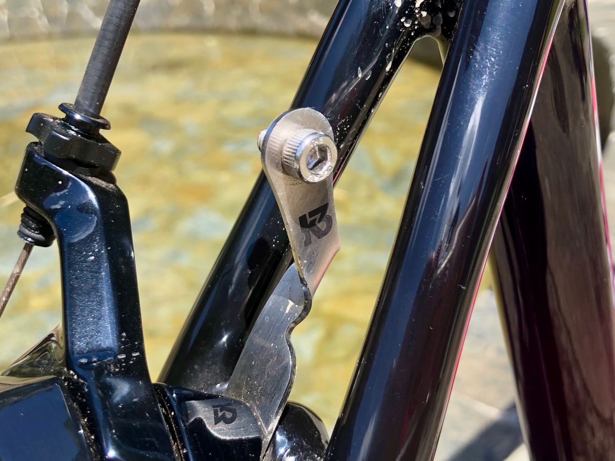 A neat number plate mount from K3 is secured with the rear brake bolt