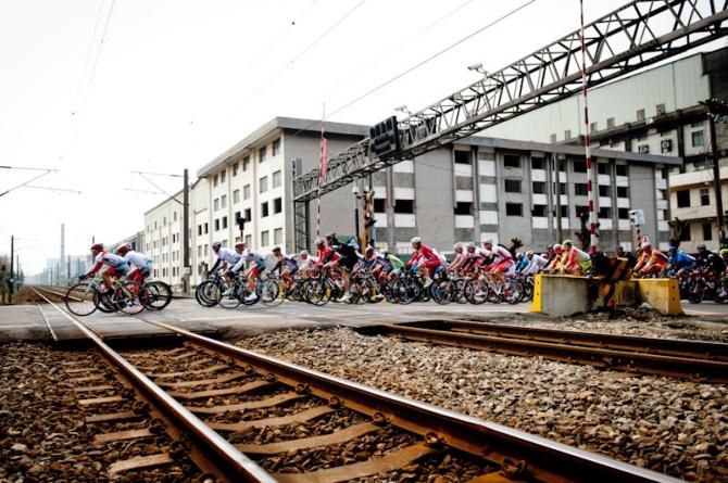 Riders cross the railway tracks at a crossing in Tour de Taiwan 2012.