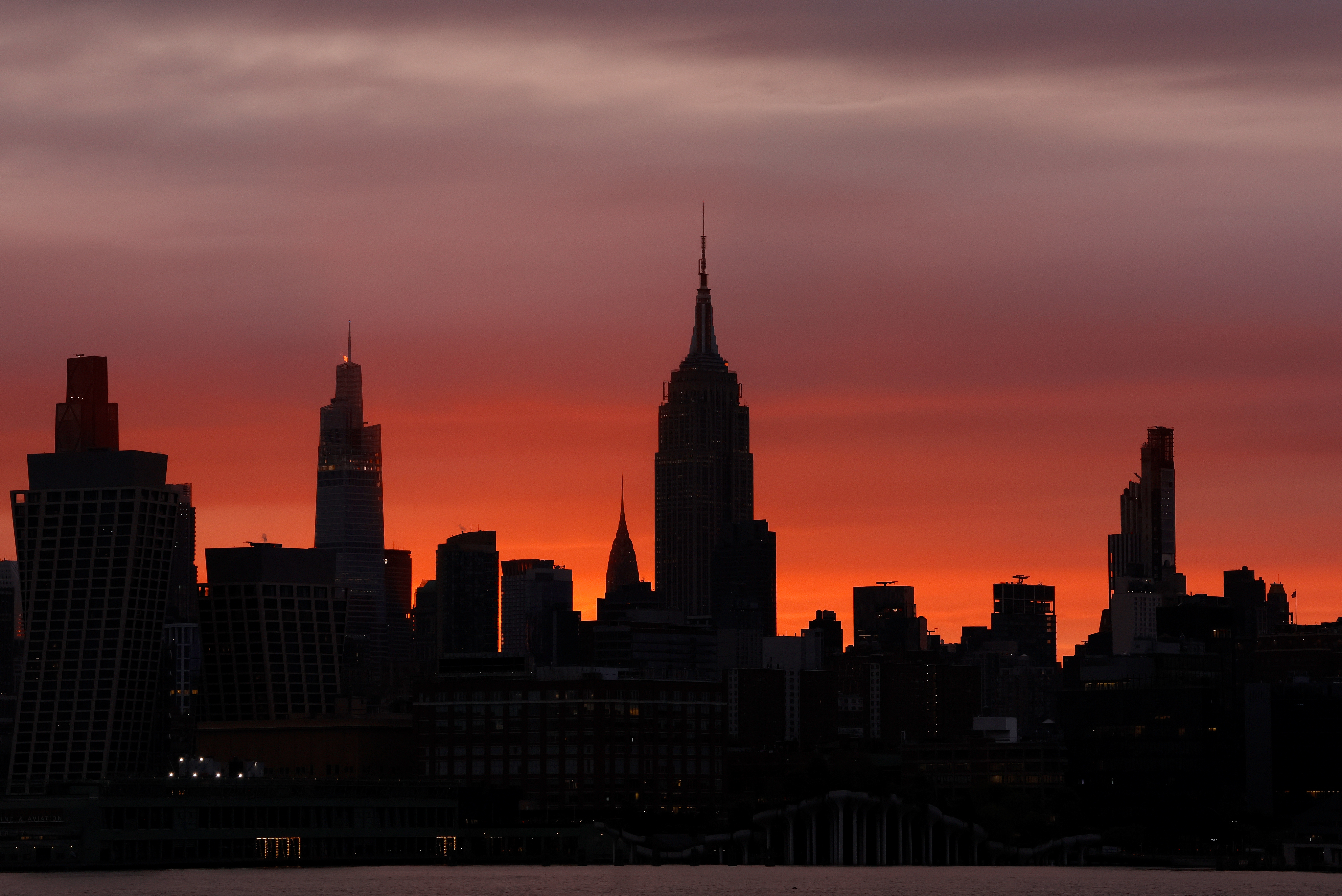 HOBOKEN, NJ - APRIL 29: The sun rises behind the skyline of midtown Manhattan and the Empire State Building in New York City on April 29, 2026, in Hoboken, New Jersey.  (Photo by Gary Hershorn/Getty Images)