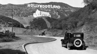 A car driving toward the Hollywoodland Sign way back in the day.