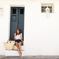 Woman in europe with a straw bag