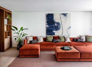 An L-shaped sofa in rust tone