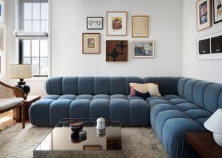 Living room with large blue sofa and gallery wall