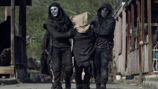 Two Reapers dragging Daryl in The Walking Dead.
