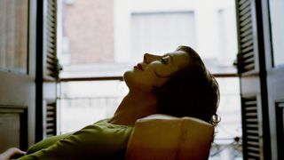 Woman sitting back in chair with closed eyes