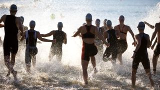 Triathletes run into water