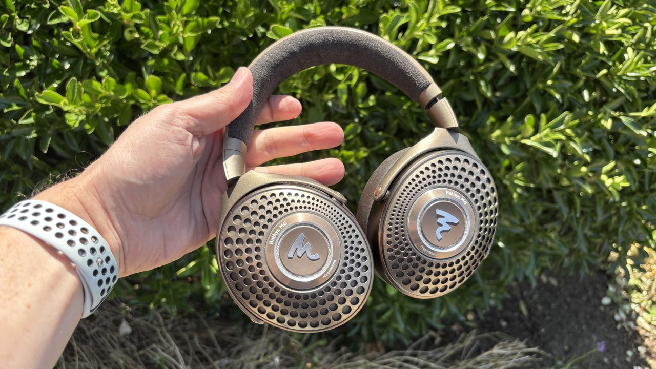 Focal Bathys Mg headphones held in hand outdoors