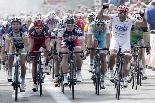Danilo Napolitano (Acqua &amp; Sapone) thinks he's won stage 1 at the Tour of Belgium, but the photo finish camera confirmed Andre Greipel (Lotto Belisol) took a narrow victory.