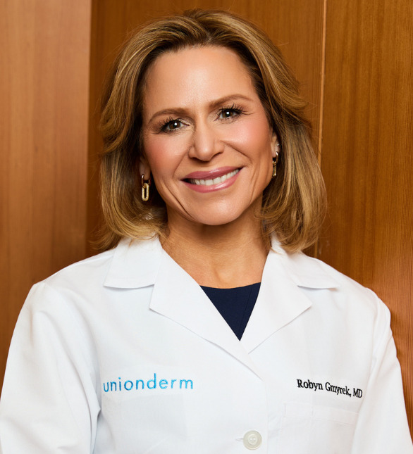 a white woman with caramel brown hair in a white lab coat