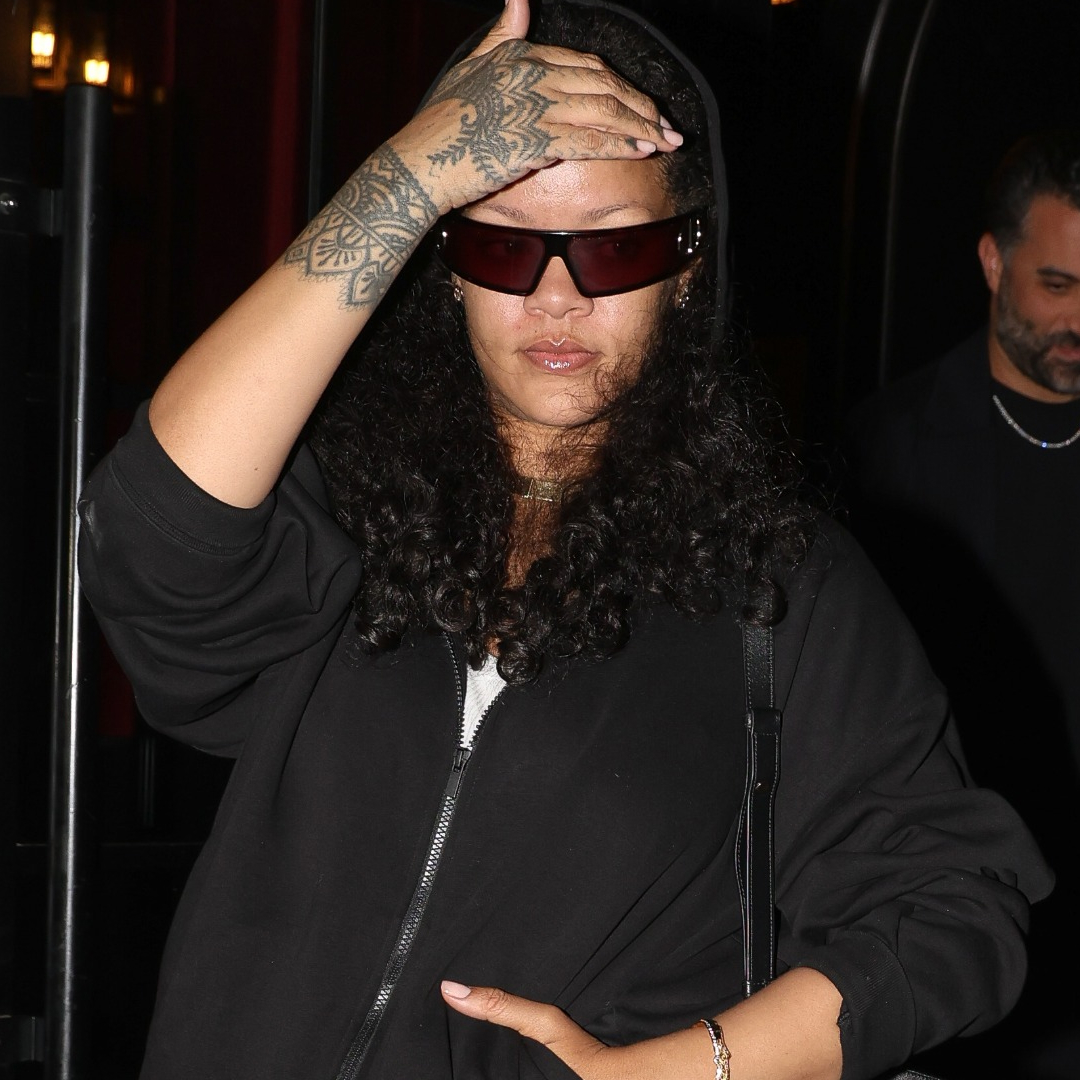 Rihanna styled a black hoodie and Dior bag with hybrid skirt and jeans bottoms
