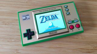 Zelda: Game and Watch on woodgrain surface with Link's Awakening on screen.