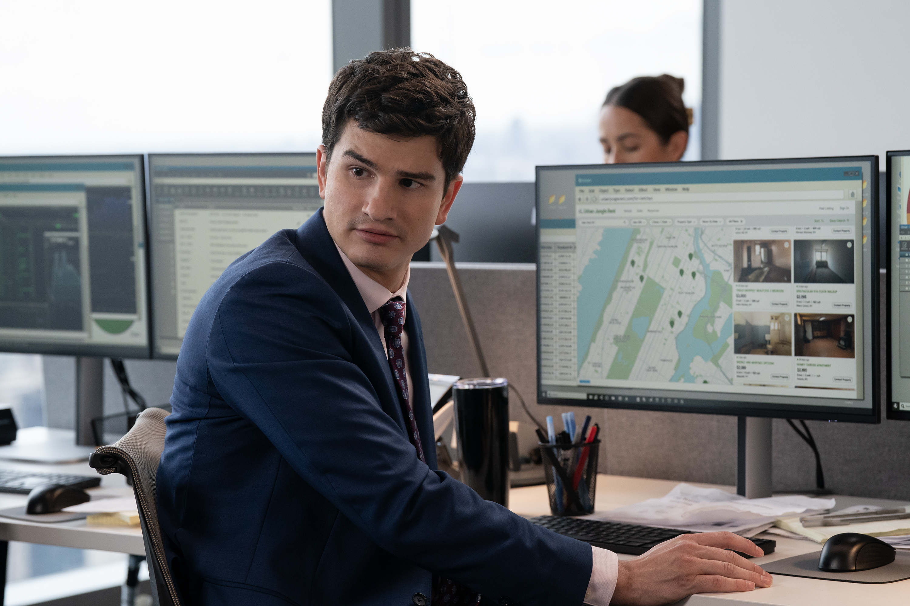 will angus as davis wearing a suit at his desk at his finance job in not suitable for work