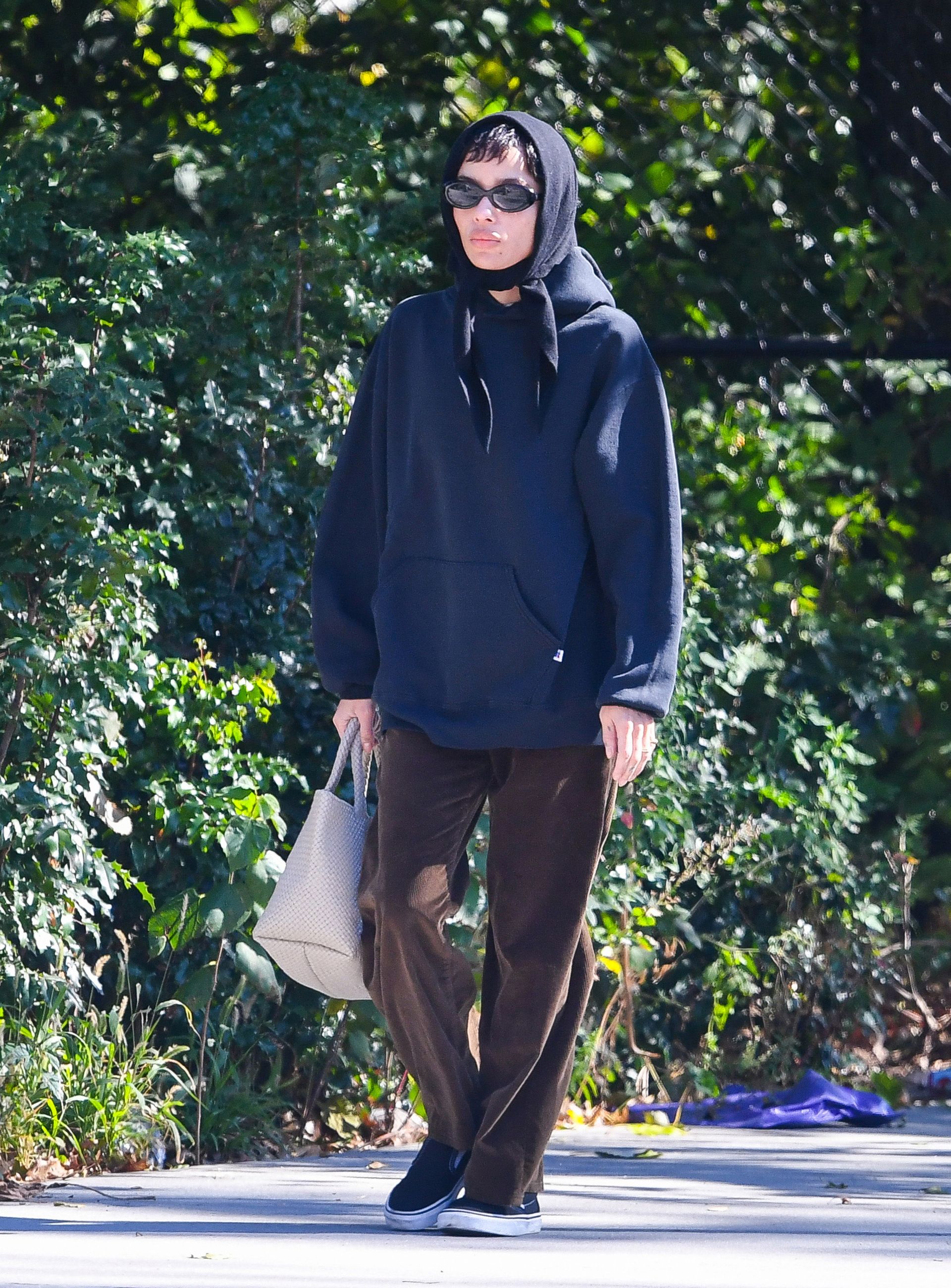 Zoë Kravitz is brown corduroys and navy sweatshirt
