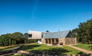 A pairing of a dramatic cantilevered extension and stone barn brings a vibrant feel to Paul and Elaine Haffey’s new home