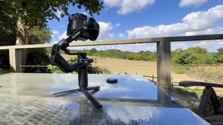 FeiyuTech SCORP Mini on a table overlooking a field