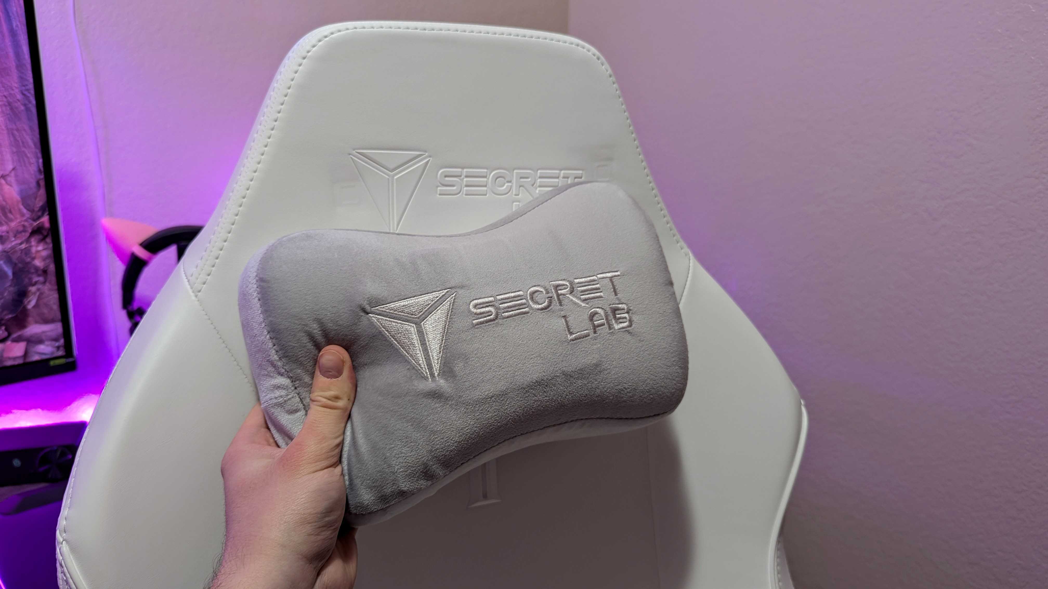 The Secretlab TITAN Evo NanoGen Edition's head rest seen up close, with the magnetically attached Memory Foam pillow held in front.