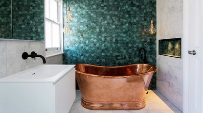 A small bathroom with copper bathtub
