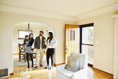 Estate agent showing a family around a house