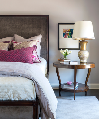 Bedroom with pastel lilac on walls and dark headboard