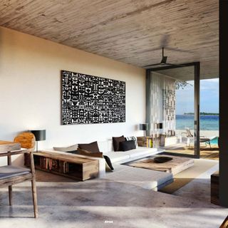 living room with art frame on wall white sofa ceiling fan and ocean view