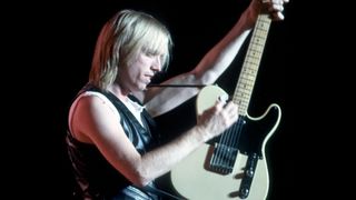 Tom Petty performs onstage with a Fender Telecaster. 