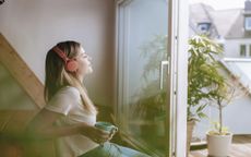 Young woman listens to music on a headset