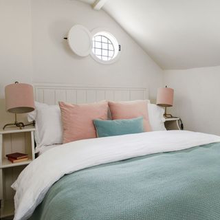 attic white bedroom with bed and lamp