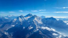 aerial view of mount everest and its surrounding peaks on a clear day with blue sku