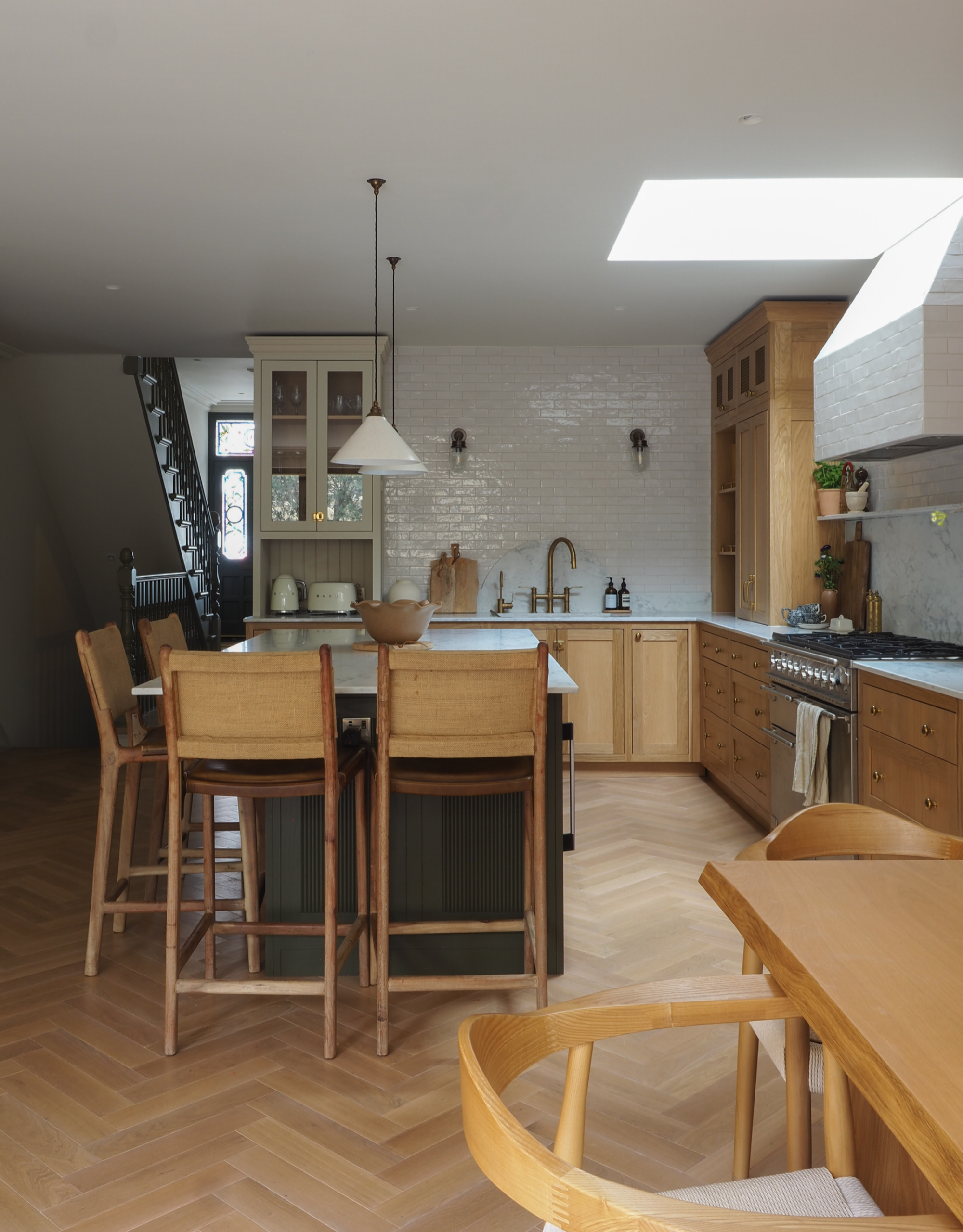 beautiful farmhouse-style kitchen with wooden cabinetry and a green island