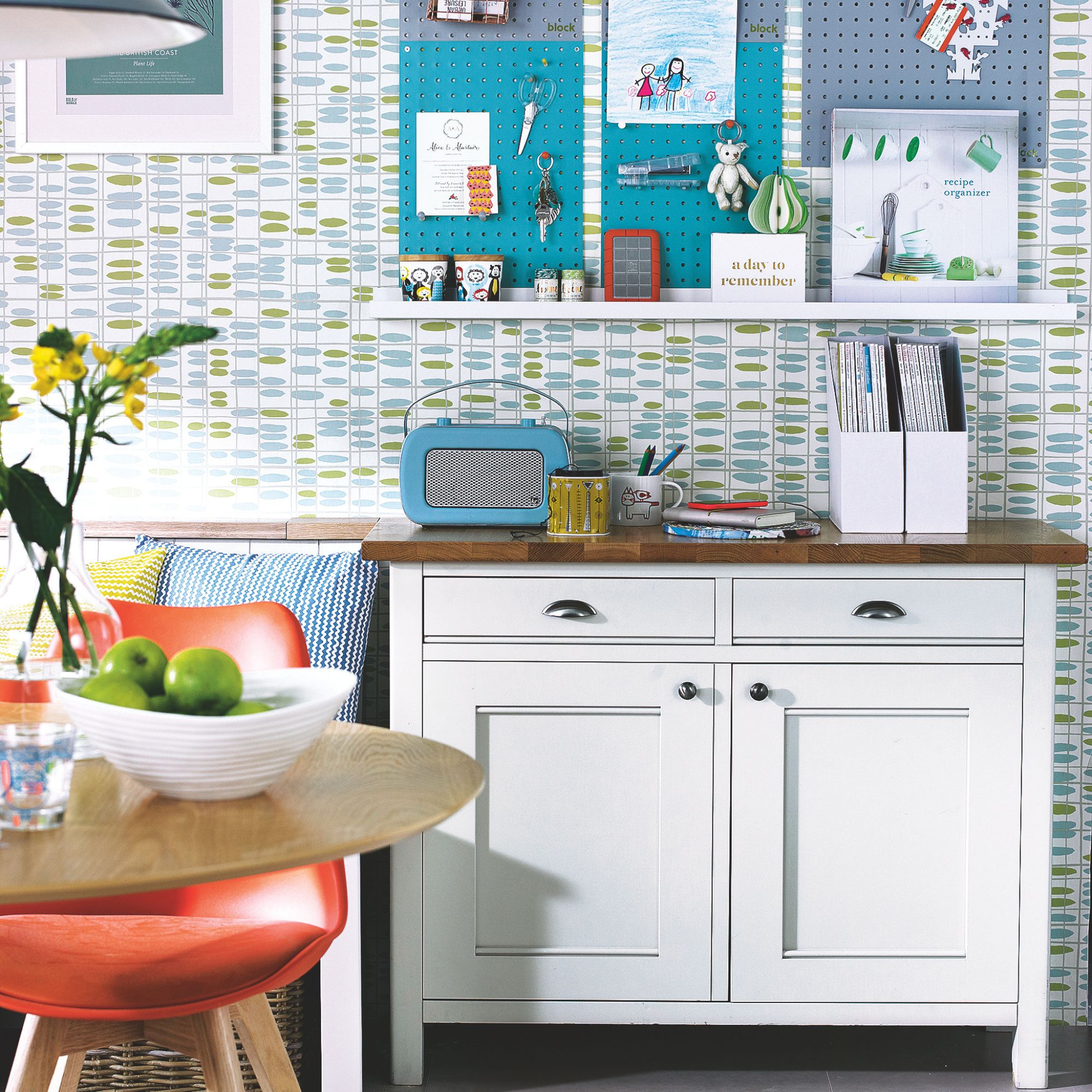 Dining room with a unit covered in pens and magazines, and a peg board above with important items pinned to it