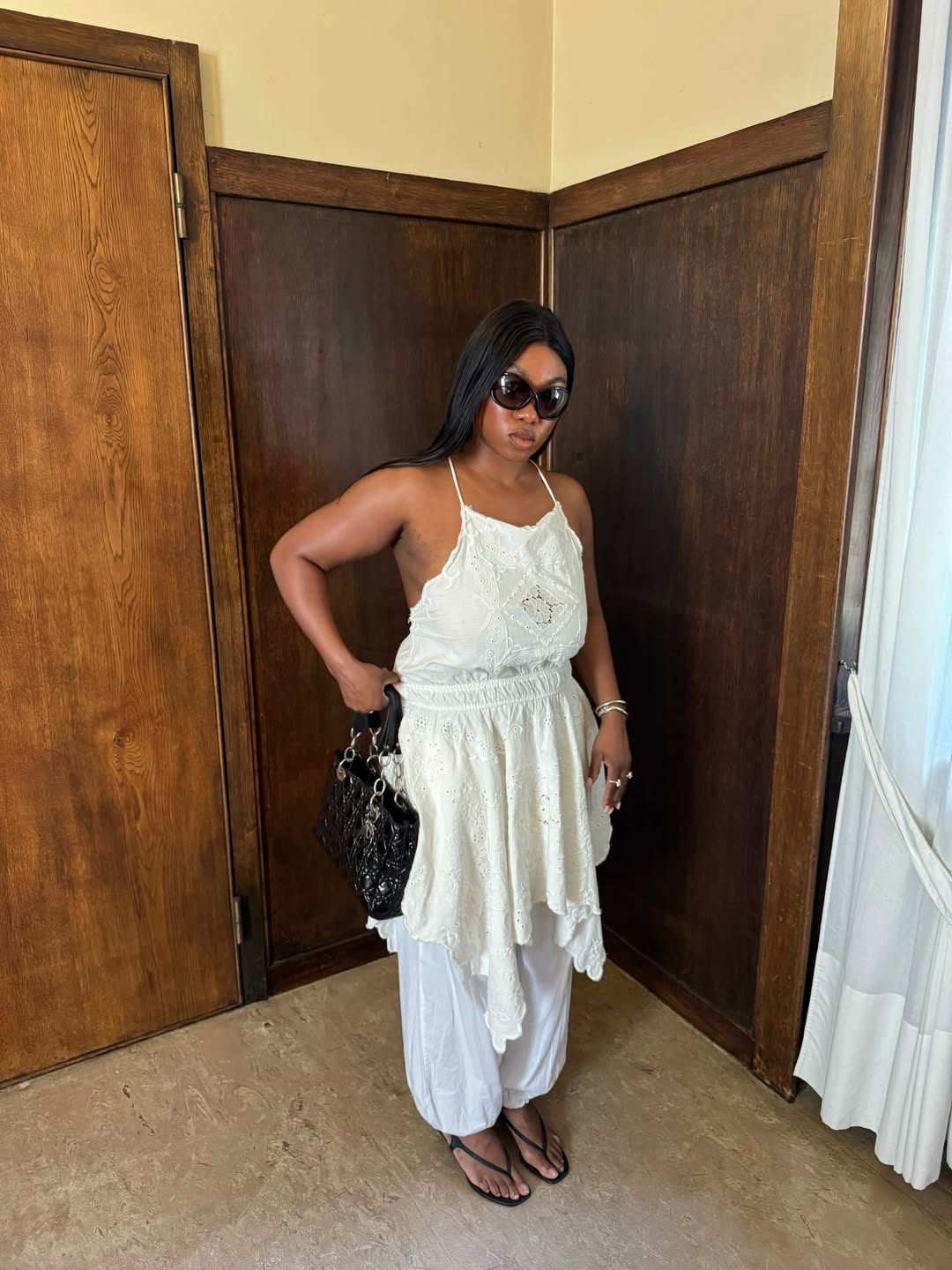 Nnenna in balloon trousers and backless white top