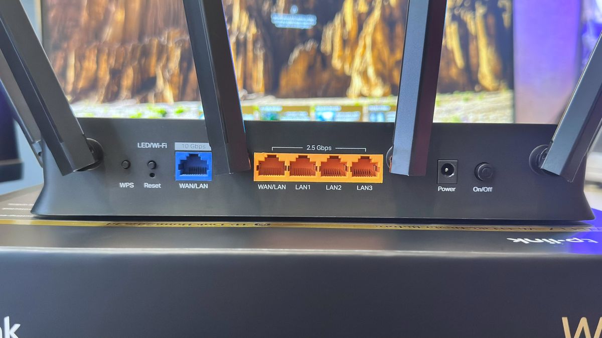 A photo of a TP-Link Archer BE9700 Wi-Fi 7 router, showing the WAN/LAN ports on the rear panel.