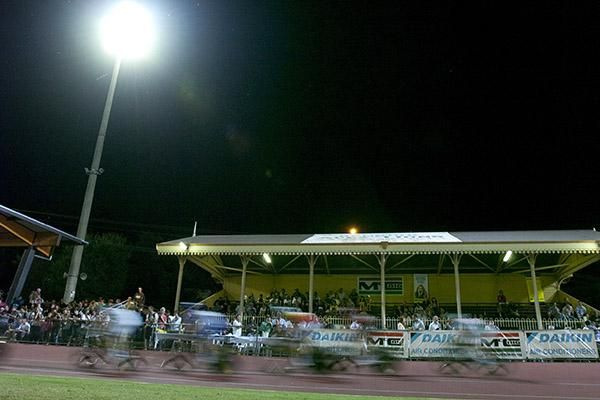 Riders speed past the historical grandstand at the Tom Flood Sports Arena.