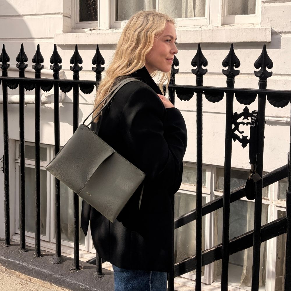 Shopping editor, Florrie, carries the Pol&egrave;ne Boky bag, wears a black blazer and blue jeans