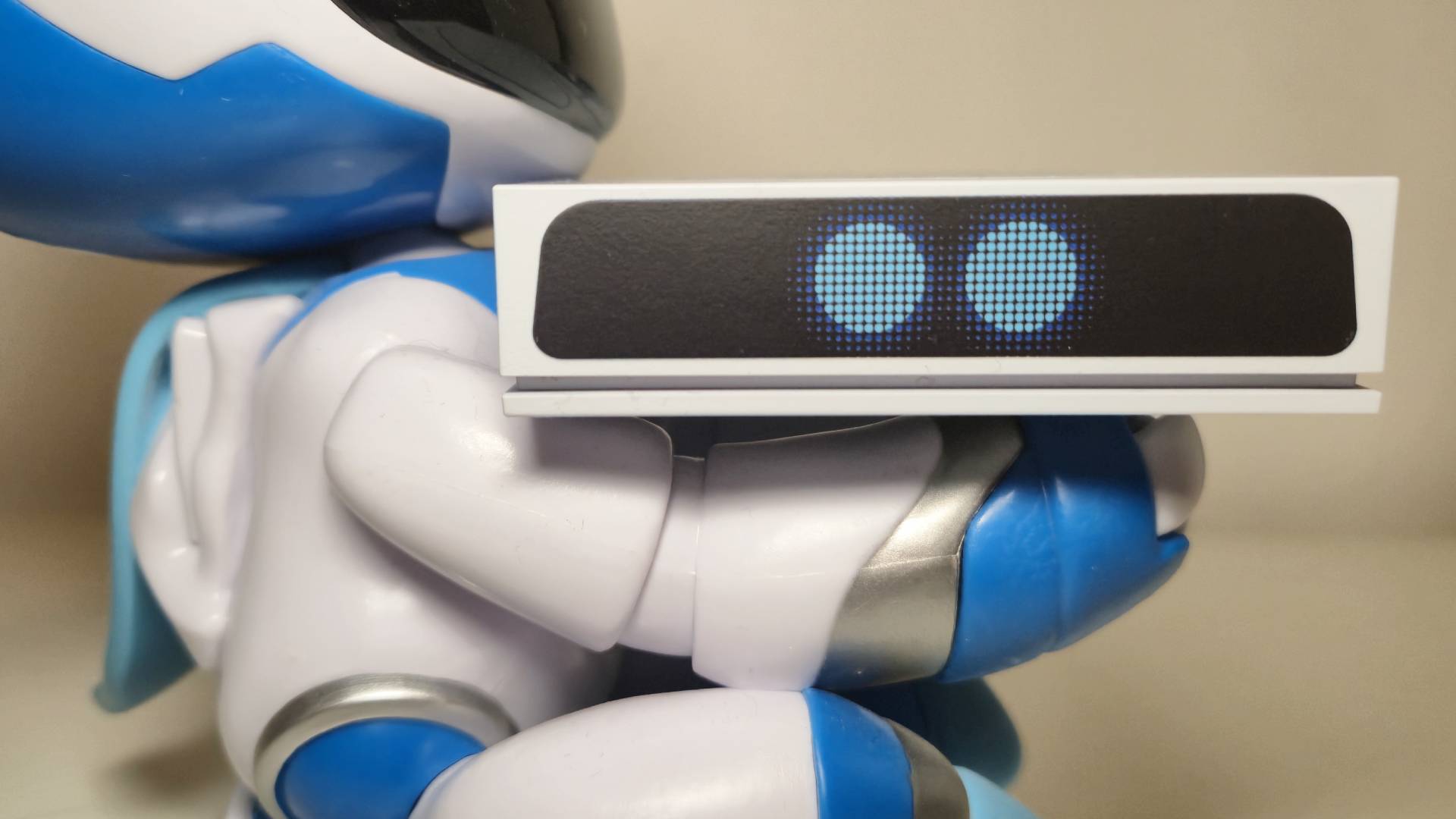 Photo of an Astro Bot figure holding the Seagate Astro Bot Game Drive.