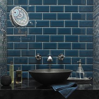bathroom with blue wallpaper wall and washbasin and blue towel