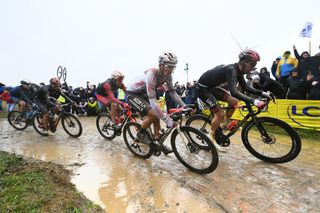 ROUBAIX FRANCE OCTOBER 03 LR Eddy Fin of France and Team Cofidis Oliver Naesen of Belgium and Ag2R Citroen Team and Mikkel Bjerg of Denmark and UAE Team Emirates compete through cobblestones sector during the 118th ParisRoubaix 2021 Mens Eilte a 2577km race from Compigne to Roubaix ParisRoubaix on October 03 2021 in Roubaix France Photo by Tim de WaeleGetty Images