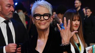 Jamie Lee Curtis wears a blue ribbon, a sign of solidarity with refugees at Baftas on stage during the EE BAFTA Film Awards 2023 at The Royal Festival Hall on February 19, 2023 in London, England.