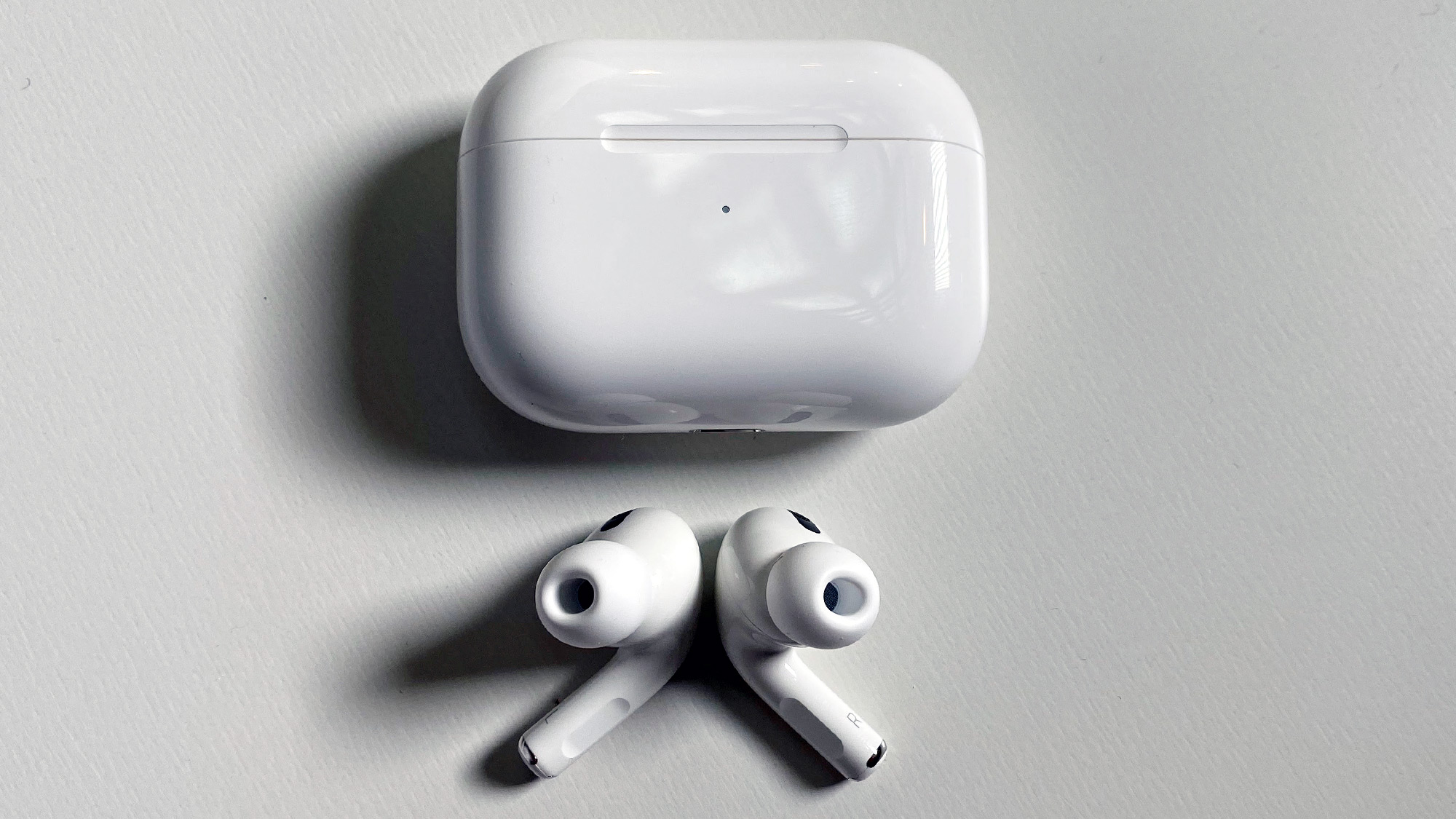 the AirPods Pro beneath their charging case