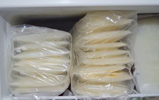 Stash of breast milk storage bags in a freezer