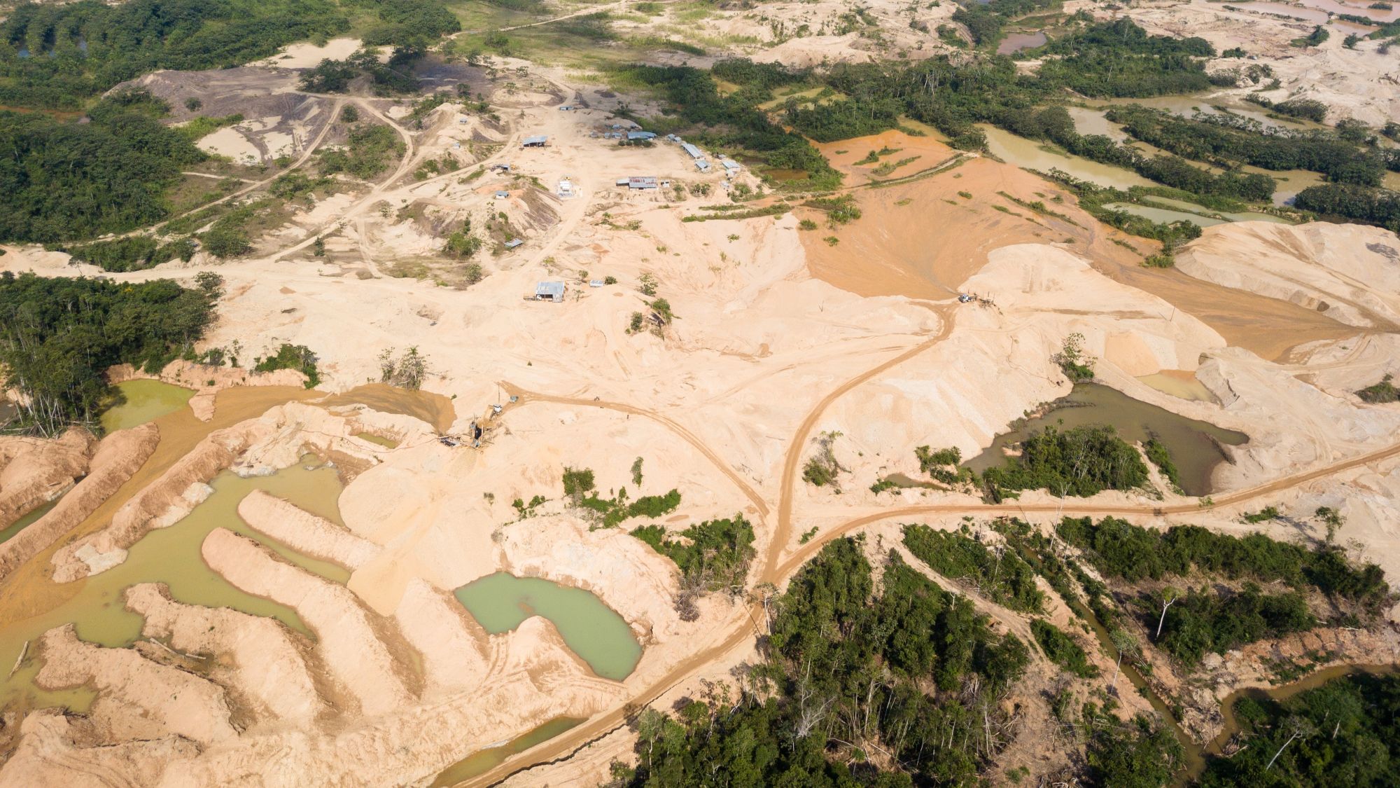 aerial view of a gold mine in peru with land dried out and small pools